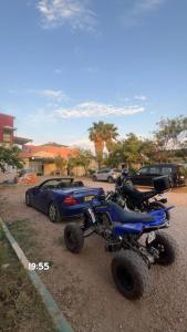 a four wheeler parked next to a parked car at La ferme labyed in Fez