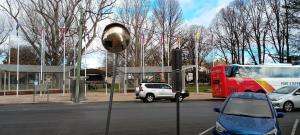 a red double decker bus on a city street at Cooma Center Cortina Studio in Cooma