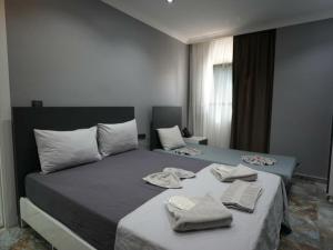 a bedroom with two beds with towels on them at Viyana Suite Hotel in Istanbul