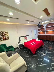 a room with a bed with a red table and chairs at Viyana Suite Hotel in Istanbul