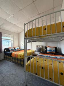 a bedroom with two beds and a bunk bed at Suncrest Hotel # Self-check-in in Blackpool