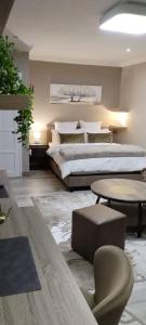 a large bedroom with two beds and a chair at Executive en-Suite, cozy, comfy and spacious in Baragwanath