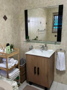 a bathroom with a sink and a mirror at Executive en-Suite, cozy, comfy and spacious in Baragwanath +15 photos