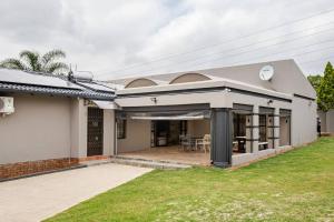 a home with a large patio in the backyard at Executive en-Suite, cozy, comfy and spacious in Baragwanath