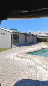a house with a swimming pool in front of it at Executive en-Suite, cozy, comfy and spacious in Baragwanath