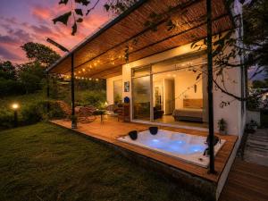 a hot tub in the backyard of a house at Finca Samana in Tocaima +10 photos