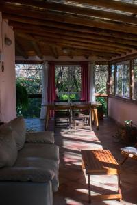 a living room with a couch and a table at Casa Armonía in Villa Las Rosas