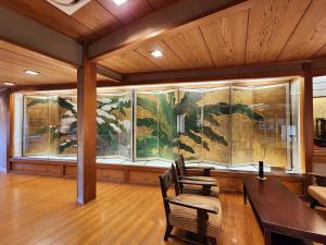 a dining room with a large painting on the wall at Chikurinin Gunpoen in Yoshino +63 photos