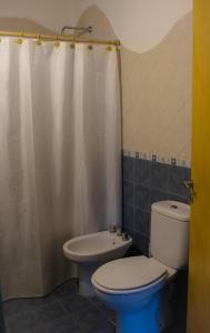 a bathroom with a toilet and a sink at Casa Armonía in Villa Las Rosas +7 photos