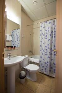 a bathroom with a toilet and a sink and a shower at Koshkin Dom in Myshkin