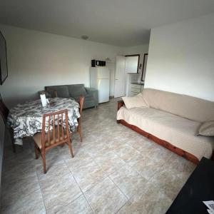 a room with a bed and a table and a couch at Casa a pie de playa in Mar de Cobo +11 photos