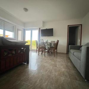 a living room with a couch and a table and chairs at Casa a pie de playa in Mar de Cobo