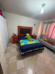 a bedroom with a bed with a stuffed animal on it at Casa Rivota in Delicias