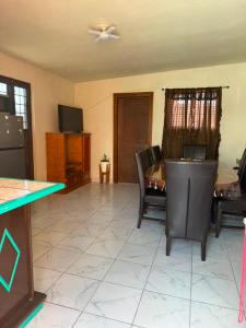 a living room with a table and chairs and a television at Casa Rivota in Delicias