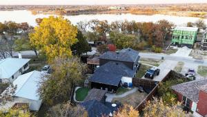 an aerial view of a house with a lake at North Shore Lake Community in The Colony