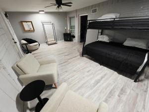 a bedroom with a bunk bed and a couch and a chair at North Shore Lake Community in The Colony