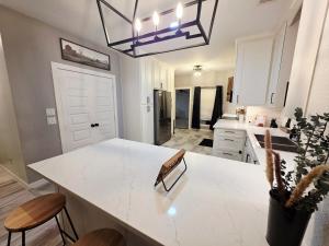a kitchen with a white counter top and a large island at North Shore Lake Community in The Colony