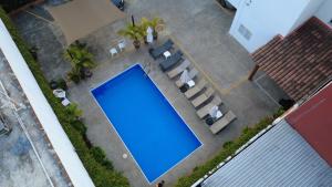 an overhead view of a blue swimming pool with lounge chairs at DEPARTAMENTOS LALO in Zihuatanejo