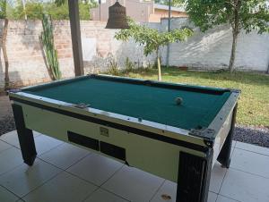 a pool table with a ball on top of it at Casa Alter do Chão Com piscina in Santarém