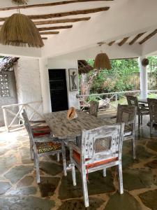 a dining room table and chairs on a patio at The Mousa House in Malindi