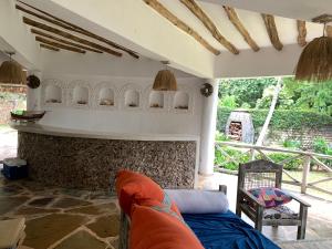 a living room with a couch and a fireplace at The Mousa House in Malindi
