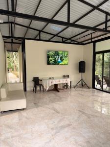 a large room with a table and chairs in it at Finca Lantana Oficial in Villeta