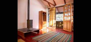 a living room with a wood burning stove in it at Casa Qenqo in Cusco