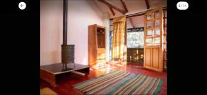 a living room with a wood burning stove in it at Casa Qenqo in Cusco