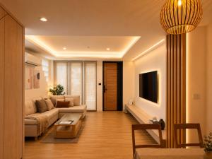 a living room with a couch and a table at Punnawithi House Bangkok in Amphoe Phra Khanong
