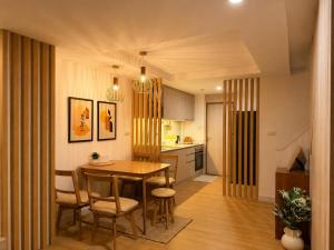 a kitchen and dining room with a table and chairs at Punnawithi House Bangkok in Amphoe Phra Khanong