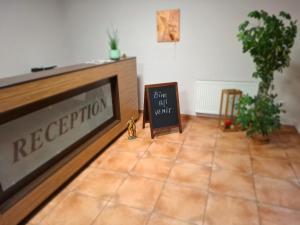 a chalkboard sign sitting on the floor in a room at Pensiune Safrane in Băile Herculane