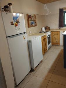 a kitchen with a white refrigerator and a stove at Casa quinta Los Teros in Sánchez de Loria +12 photos