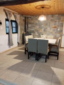 a dining room with a table and chairs at Casa quinta Los Teros in Sánchez de Loria