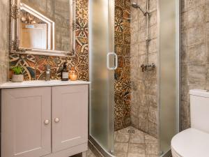 a bathroom with a shower and a sink and a toilet at KUBU Loft in Klaipėda +33 photos