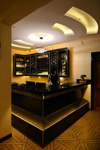 a bar with a person sitting at a counter at Neon Hotel in Kampala