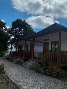 a house with a porch and a walkway at Katra Sembalun in Sembalun Lawang