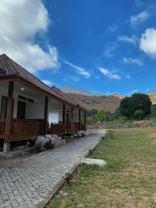 a house with a brick walkway in front of it at Katra Sembalun in Sembalun Lawang