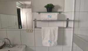 a bathroom with white towels and a sink and a mirror at HOTEL MURCIA AREQUIPA in Arequipa +25 photos
