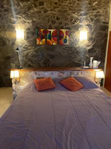 a bedroom with a bed with two pillows on it at Huellas de Berna in Villa Berna