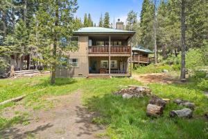 a house in the woods with a yard at Stargazing Retreat in Tamarack in Big Creek
