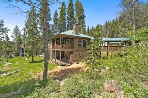 a large house in the woods with trees at Stargazing Retreat in Tamarack in Big Creek