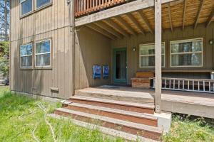 a house with a porch and stairs leading to a door at Stargazing Retreat in Tamarack in Big Creek