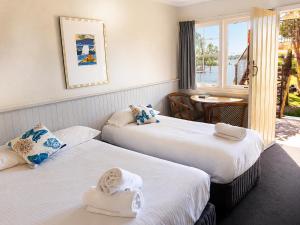 a hotel room with two beds with towels on them at Squid's Ink Motel in Belmont
