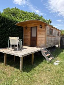 a tiny house with a deck and chairs on it at Chicken roulotte des 3 cèdres in Cavaillon +7 photos