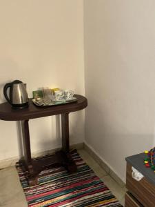 a table with a tea kettle on it in a room at Akhnaton pyramids inn in Cairo