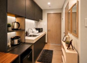 a kitchen with a sink and a counter top at The Narci Suites in Manila