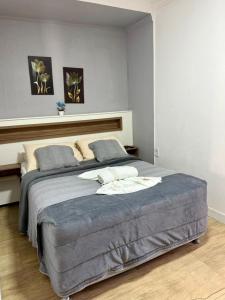a bedroom with a large bed in a room at Hotel Estrela do Mar in Penha