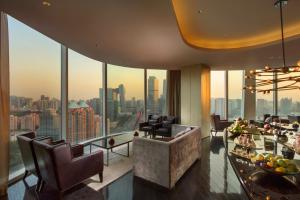 a living room with a view of a city at Conrad Beijing by Hilton in Beijing