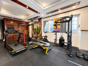 a gym with several treadmills and machines in a room at A25 Hotel - 44 Hàng Bún in Hanoi