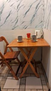 a wooden table with two laptops on top of it at CHE LOLITA HOUSE 2 in Buenos Aires +8 photos